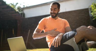 Man enjoying YMCA360 on laptop